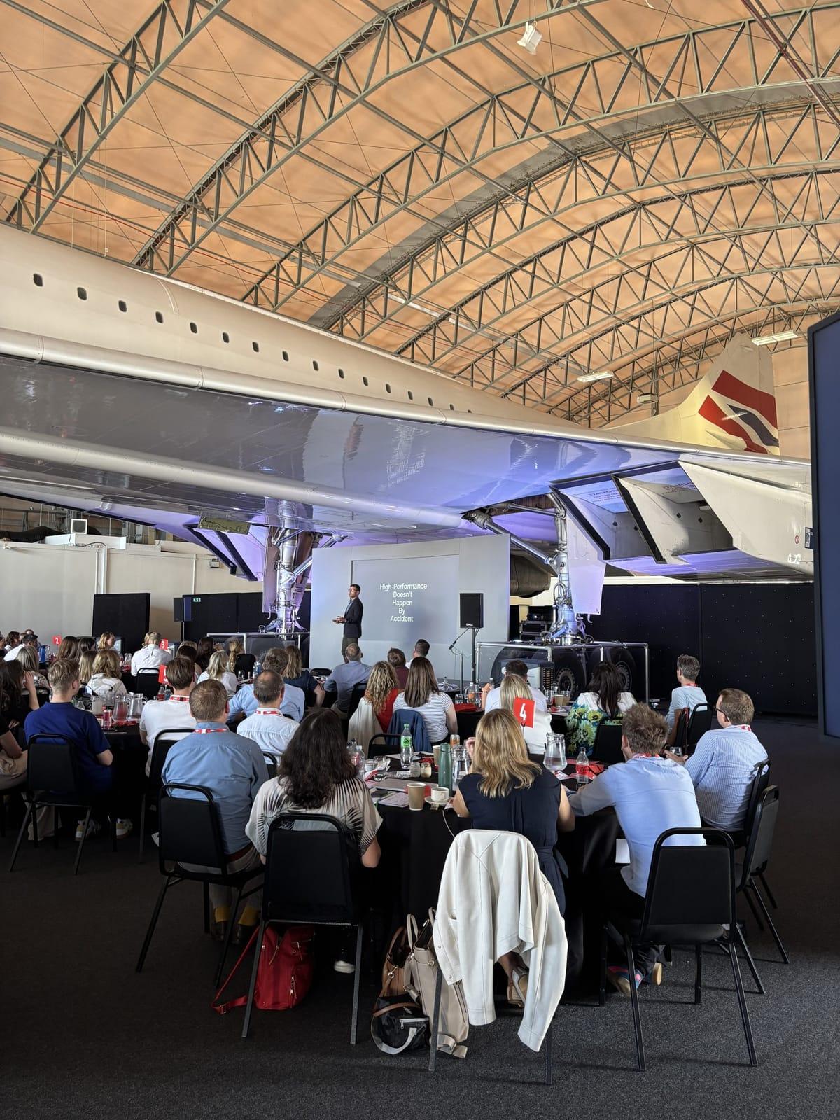 Steve Ingham presenting beneath a Concorde aircraft